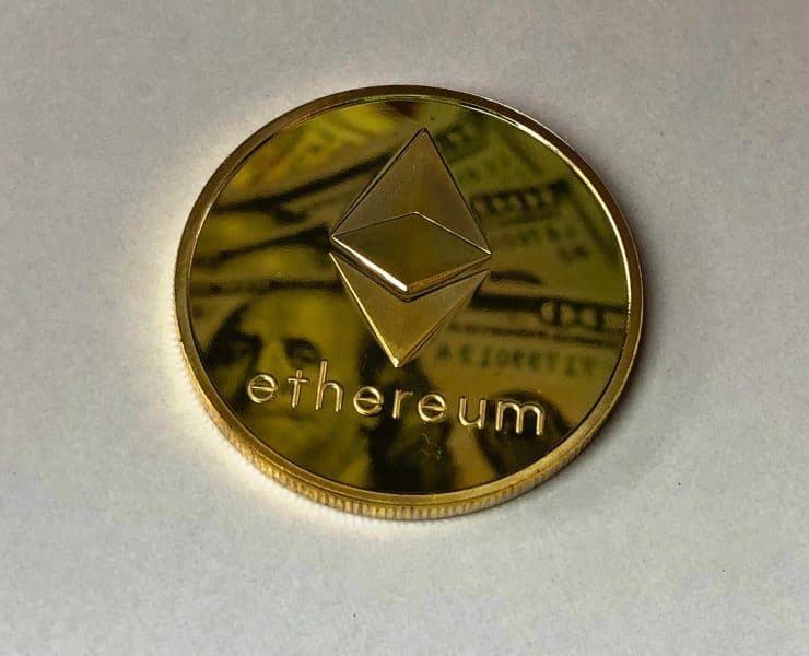 round gold colored ethereum ornament