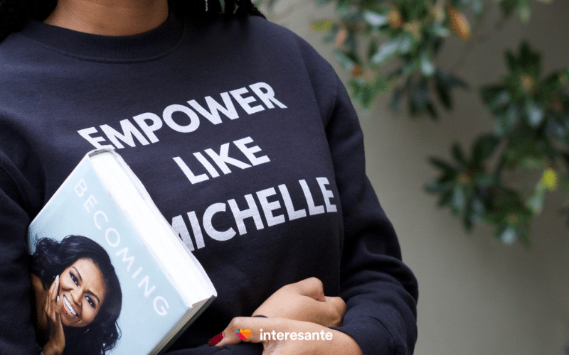 Chica con sudadera Empower like Michelle y libro Becoming